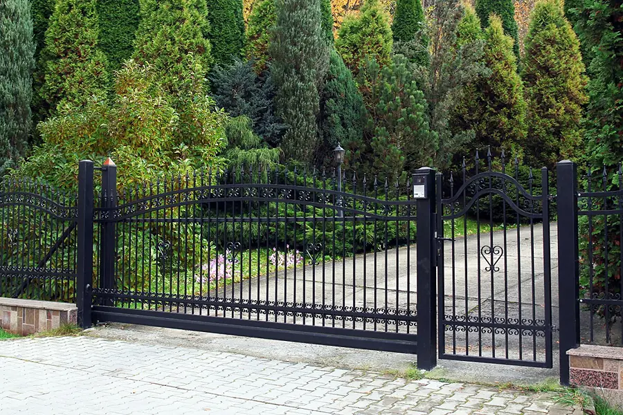 Black metal driveway gates and railings – a gate style offered by fencers in Weston-super-Mare